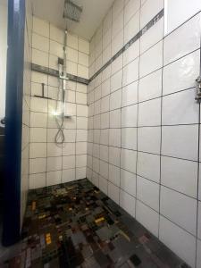 a bathroom with a shower and a tiled floor at L'Alcôve, maison d'artistes in Sacquenay +32 photos