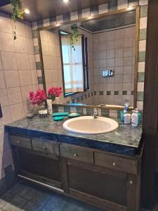 a bathroom with a sink and a mirror at Villa Pina 100 meters from the sea in Fort Village