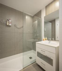 a bathroom with a shower and a sink and a mirror at Fantastic beach apartment near Valencia in Valencia