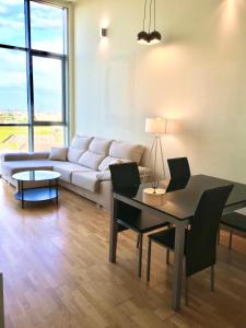 a living room with a couch and a table at Panoramic Suites By VALENCIAFLATS EU in Valencia +5 photos