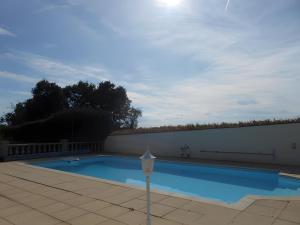 a swimming pool next to a white wall at Chez Louis in Revel-Tourdan +37 photos