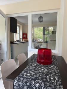 a kitchen with a table with a red bowl on it at LIVA LIVING, Apartments mit Berg- und Seeblick, große Terrassen in Sankt Gilgen
