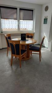 ein Zimmer mit einem Tisch und Stühlen und einem Laptop darauf in der Unterkunft Ferienwohnung Kleine Auszeit in Schönau im Schwarzwald
