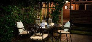 a table and four chairs and a table and chairs at Beach Approach Cottage - 30 steps from beach - Luxury house with covered table tennis - Netflix Smart TV in Filey