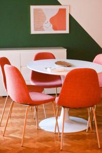a table with four chairs and a white table at Prestige and comfort in the center of Perugia and views in Perugia