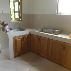 a kitchen with a sink and a counter top at Gagana vila in Katugastota