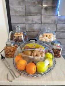 a table with a plate of fruit and other foods at Luz de Salento B&B in Lecce