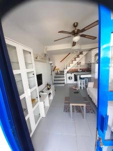 a room with white bunk beds and a ceiling fan at Casa Romantico - Playmar - Maspalomas in Maspalomas