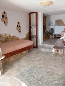 a bedroom with a bed and a stone wall at Lucas B Panorama in Sikinos