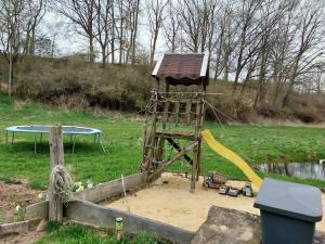 a playground with a tower and a slide at Eselstall Karl in Löhma +14 photos