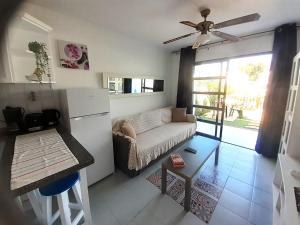 a living room with a couch and a table at Casa Romantico - Playmar - Maspalomas in Maspalomas