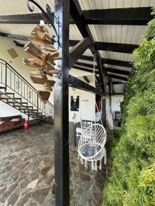 a room with two chairs and a table and stairs at Cabana Diana in Avrig
