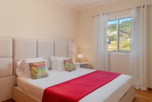 a bedroom with a large white bed with a window at Strategic Sunset House by An Island Apart in Santa Cruz