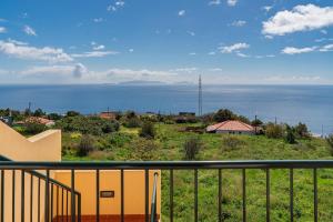 a view of the ocean from the balcony of a house at Strategic Sunset House by An Island Apart in Santa Cruz