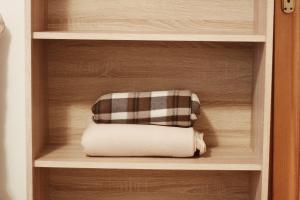 a stack of folded towels in a cabinet at Apartment Baščaršija-parking i klima in Sarajevo