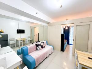 a living room with a blue couch in a room at Sea Residences Navigators in Manila