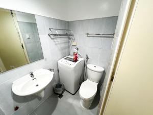 a bathroom with a white toilet and a sink at Sea Residences Navigators in Manila +62 photos
