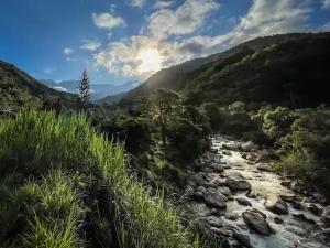 a river in the middle of a valley at Kubla Khan - Chirripó Mountain Riverfront Retreat in Rivas +68 photos