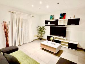 a living room with a flat screen tv on a wall at Gloria Seaviews in Manacor