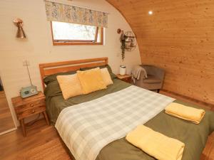 a bedroom with two beds in a log cabin at Cabanau Bach in Caerphilly