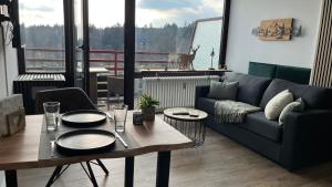a living room with a couch and a table at Ferienwohnung Panoramablick Hahnenklee in Goslar