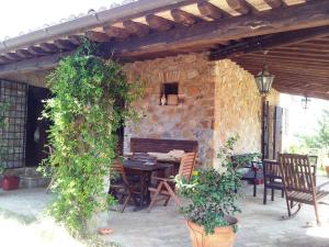 an outdoor patio with a wooden table and a bench at Casale La Quercia in Pian D'artino