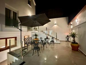 a patio with a table and chairs and an umbrella at GH Beiramar in Cee