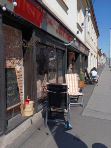 a couple of chairs sitting outside of a store at Apartments Bouquet in Prague