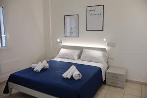 a bedroom with a bed with two towels on it at Dreamhouse - The Apartment in Leverano