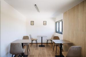 a group of tables and chairs in a room at Heaven Room in Striano