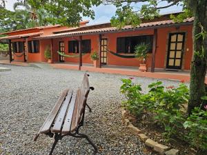 a wooden bench sitting in front of a building at Pousada do Alferes in Paty do Alferes