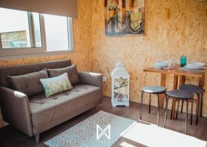 a living room with a couch and a table at MyStay - Bungalows in Quinta dos Sobrais in Valença