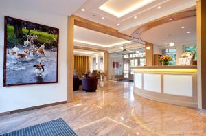 a lobby with a large painting of dogs in the water at Hotel Hof Sudermühlen in Egestorf