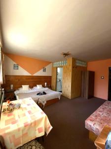 A bed or beds in a room at Penzión Skitour
