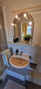 a bathroom with a sink and a mirror at MALA Modern Vienna Flair Apartment Donaustadt in Vienna