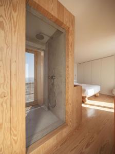 a bathroom with a shower with a glass door at LIOZ Hotel & Apartments in Lisbon +102 photos
