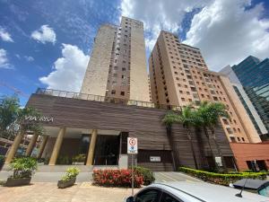 a building with two tall buildings in a city at Via Brisa Apartment in Brasília