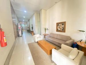 a living room with a couch and a coffee table at Via Brisa Apartment in Brasília