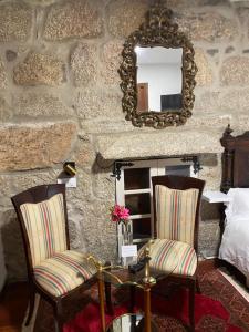 a room with two chairs and a table and a mirror at Hotel Rural VN Tenorio in Pontevedra +86 photos