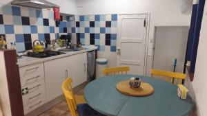 a kitchen with a table with a hat on it at Blue&YellowHouse in Alcoutim