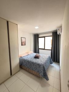 a small bedroom with a bed and a window at Via Brisa Apartment in Brasília +31 photos