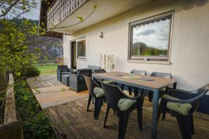 a wooden table and chairs on a deck at Kleiner Urlaub in Beuron