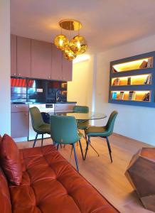 a living room with a couch and a table and chairs at Piscis Of The Sea Benidorm in Benidorm
