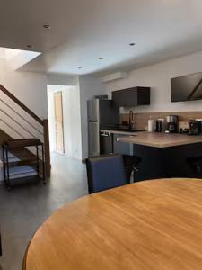 a room with a table and a kitchen with a tableablish at La Risloise in Pont-Audemer