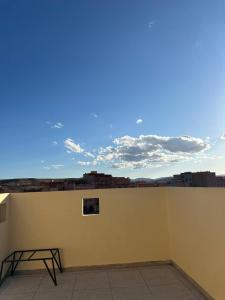 a building with a table on the side of a wall at Residence Dallas Warzazate in Ouarzazate +1 photo