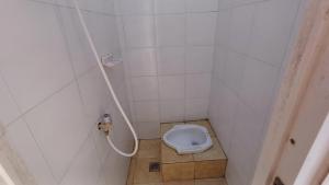 a small bathroom with a toilet in a stall at Kost Carmelia Syariah Baranangsiang Bogor in Bogor +21 photos