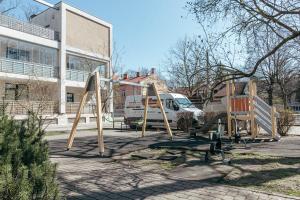 a group of playground equipment in front of a building at Modern Flat near City Center with Parking, Smart TV & Wi-Fi in Rīga