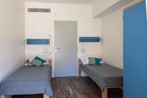 Postel nebo postele na pokoji v ubytování Caravelle 60