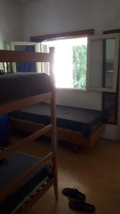a room with a bunk bed and a window at Casa en el Río in Alpa Corral