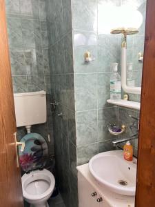a bathroom with a toilet and a sink at Home NP Apartments in Novi Pazar +23 photos
